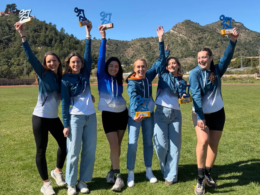 Socias del BCS levantando sus trofeos con la sierra de fondo
